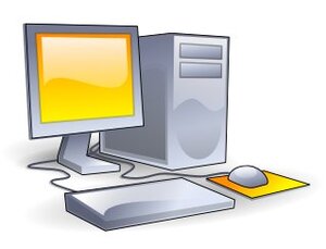 A grey computer system with a yellow screen and mouse pad